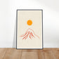 Orange sun over red mountain art print in a black wood frame, 60x90 cm